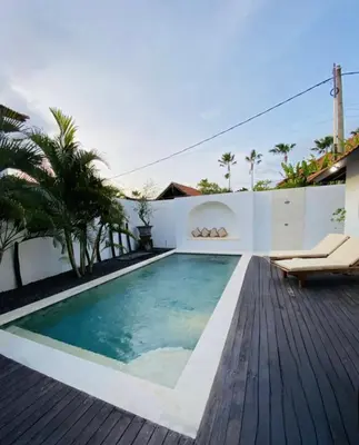 a swimming pool in the backyard of a house at Casa Praja in Seminyak