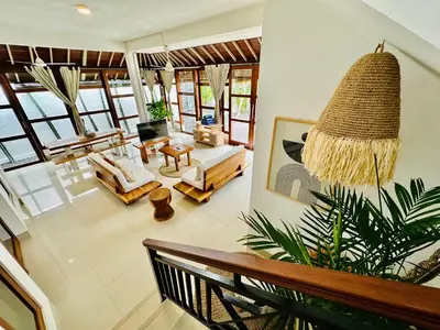 a living room with a couch and a table at Casa Praja in Seminyak