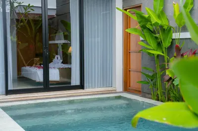 a swimming pool in front of a house at Villa Bulan Bali in Jimbaran