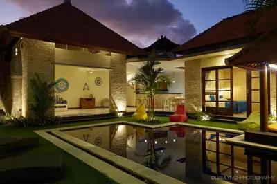 a house with a swimming pool in front of it at Villa Jae in Seminyak