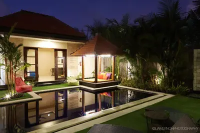 a house with a pool in the yard at night at Villa Jae in Seminyak