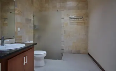 a bathroom with a toilet and a sink and a shower at Villa Jae in Seminyak
