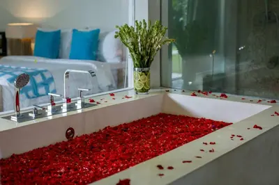 a sink full of red petals in a room at Villa Jumah in Canggu