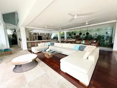 a living room with a white couch and a table at Villa Jumah in Canggu