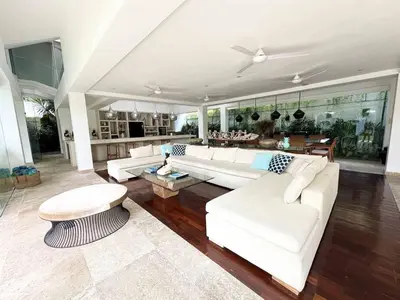 a living room with a white couch and a table at Villa Jumah in Canggu