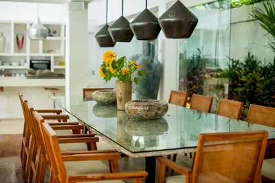 a dining room with a glass table with chairs at Villa Jumah in Canggu
