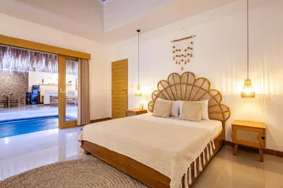 a bedroom with a bed and a pool at Simple & Magical Villas . Villa Sambali 2 in Kuta