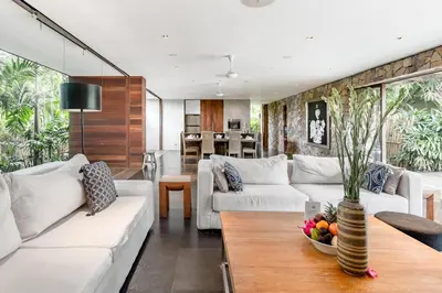 a living room with white couches and a table at Wahyu wonderful 4Bd villa with huge garden and 2 pools in Seminyak