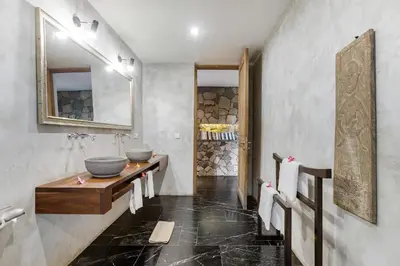 a bathroom with two sinks and a counter with a mirror at Wahyu wonderful 4Bd villa with huge garden and 2 pools in Seminyak