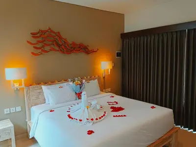 a bedroom with a bed with a cake on it at Kubu Garden Suites & Villas Nusa Dua in Nusa Dua