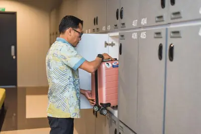 a man standing in a kitchen with a machine at PassGo Digital Airport Hotel Bali in Kuta