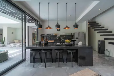 a kitchen with a large island with bar stools at Villa Prana - High End Boutique Style Interior Design 5 BR Villa in Canggu