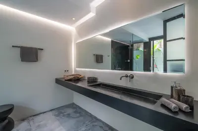 a bathroom with a sink and a mirror at Villa Prana - High End Boutique Style Interior Design 5 BR Villa in Canggu