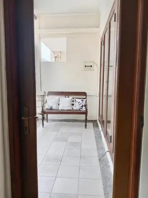 a hallway with a bench in a room at Turtledove Guesthouse in Kerobokan