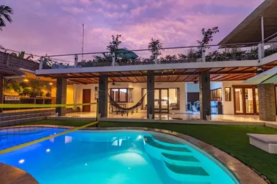 an exterior view of a house with a swimming pool at 5 BR Villa Sultan Luxury Entertainment and Relaxation in Seminyak