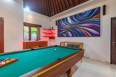 a pool table in a room with a painting at 5 BR Villa Sultan Luxury Entertainment and Relaxation in Seminyak
