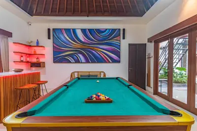 a pool table in a room with a painting at 5 BR Villa Sultan Luxury Entertainment and Relaxation in Seminyak