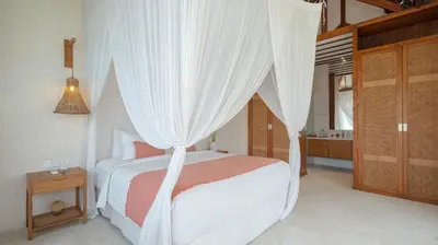 a bedroom with a bed with a canopy at Villa Aloui by Villa Finder in Kerobokan