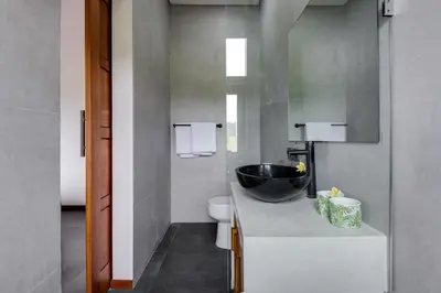 a bathroom with a sink and a toilet at 2 Zen Bali Villa Canggu in Canggu