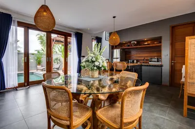 a dining room with a glass table and chairs at 2 Zen Bali Villa Canggu in Canggu
