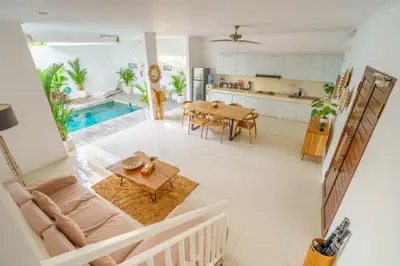 a kitchen and living room with a table and a dining room at Selog Seven in Seminyak