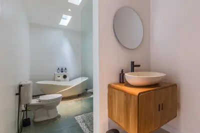 a bathroom with a sink and a toilet and a mirror at Charming 3 Bedrooms Villa Beach Walking Distance in Seminyak