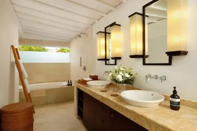 a bathroom with two sinks and a tub at Villa Swarna by Nakula in Seminyak