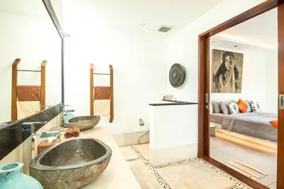 a bathroom with two sinks and a bed at Villa Nikko I - 4Br Villa in Central Seminyak, Steps to Cafés & Shops in Seminyak