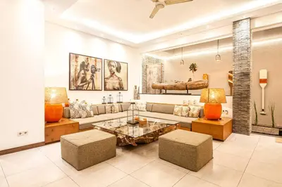 a living room with a couch and a table at Villa Nikko I - 4Br Villa in Central Seminyak, Steps to Cafés & Shops in Seminyak