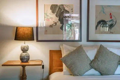 a bedroom with a bed with a lamp on a table at Villa Amore - Elegant 4-br Villa close to the beach in Canggu