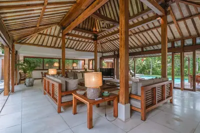 an open living room with a large wooden ceiling at Villa Amore - Elegant 4-br Villa close to the beach in Canggu