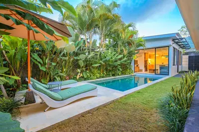 a backyard with a swimming pool and a house at 4 Bdr -Villa Donna, Fast Wi-Fi & Private Pool in Canggu