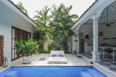 a villa with a swimming pool and a house at Villa Kayan - Gorgeous 2BR Seminyak gem, fabulous location steps from restaurants, cafes and shopping in Seminyak