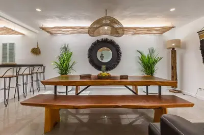a dining room with a table and a mirror at Central 4 bedr villa 5min walk from eat street&Beach in Seminyak