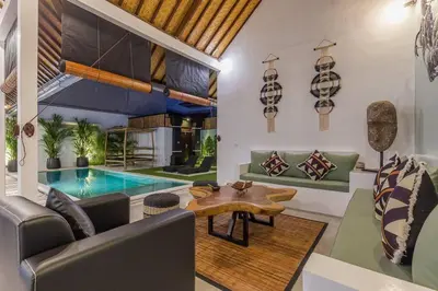 a living room with a table and a pool at Central 4 bedr villa 5min walk from eat street&Beach in Seminyak
