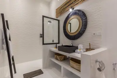 a bathroom with a sink and a mirror on the wall at Central 4 bedr villa 5min walk from eat street&Beach in Seminyak
