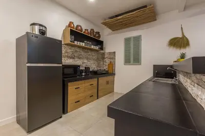 a kitchen with a stainless steel refrigerator and wooden cabinets at Central 4 bedr villa 5min walk from eat street&Beach in Seminyak