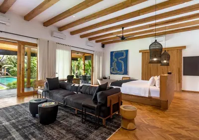 a living room with a couch and a bed at Villa Wolfe by Villa Finder in Seminyak