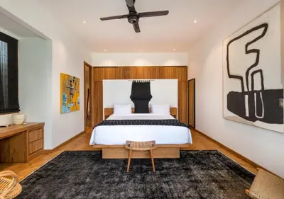 a bedroom with a bed and a ceiling fan at Villa Wolfe by Villa Finder in Seminyak