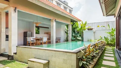 a swimming pool in the backyard of a house at Cosy and Cheerful 2 Bedroom villa 5mins to Finns in Canggu