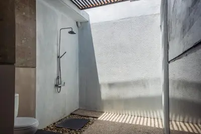 a bathroom with a shower and a toilet at Cosy and Cheerful 2 Bedroom villa 5mins to Finns in Canggu