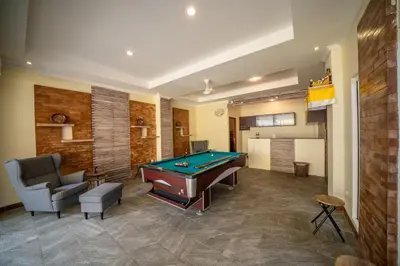 a living room with a pool table and a couch at Padma Lodge Legian in Seminyak