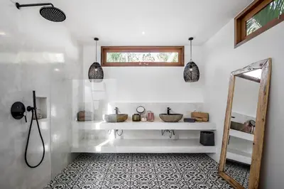 a white bathroom with a mirror and a sink at Villa Cocotier by Alfred in Bali in Seminyak