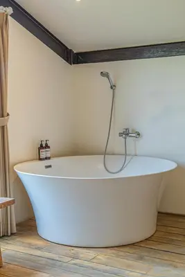 a white bath tub in a room with a shower at Villa Elma - Huge 2-bedroom pool villa in Umalas! in Seminyak