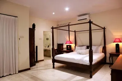a bedroom with a canopy bed in a room at KUTA - 4BR Villa with Private XL Pool in Kuta