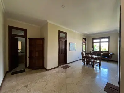 a living room with a table and a dining room at KUTA - 4BR Villa with Private XL Pool in Kuta