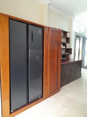 a large glass door in a kitchen with a cabinet at KUTA - 4BR Villa with Private XL Pool in Kuta