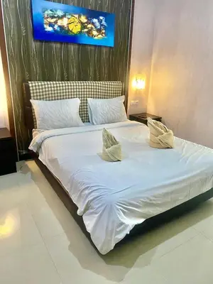 a large white bed with two pillows on it at NEW KUBU DI BUKIT apartemen & motor bike rental near beach and 10 minute to airpot in Jimbaran