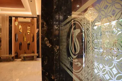 a hallway with a door and a chandelier at Dream of Aventus Hotel Kuta in Kuta