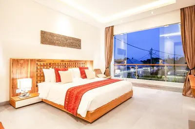 a bedroom with a large bed and a large window at Exquisite 4Bd Gem, 5min to Finns Coastal Vibe in Canggu